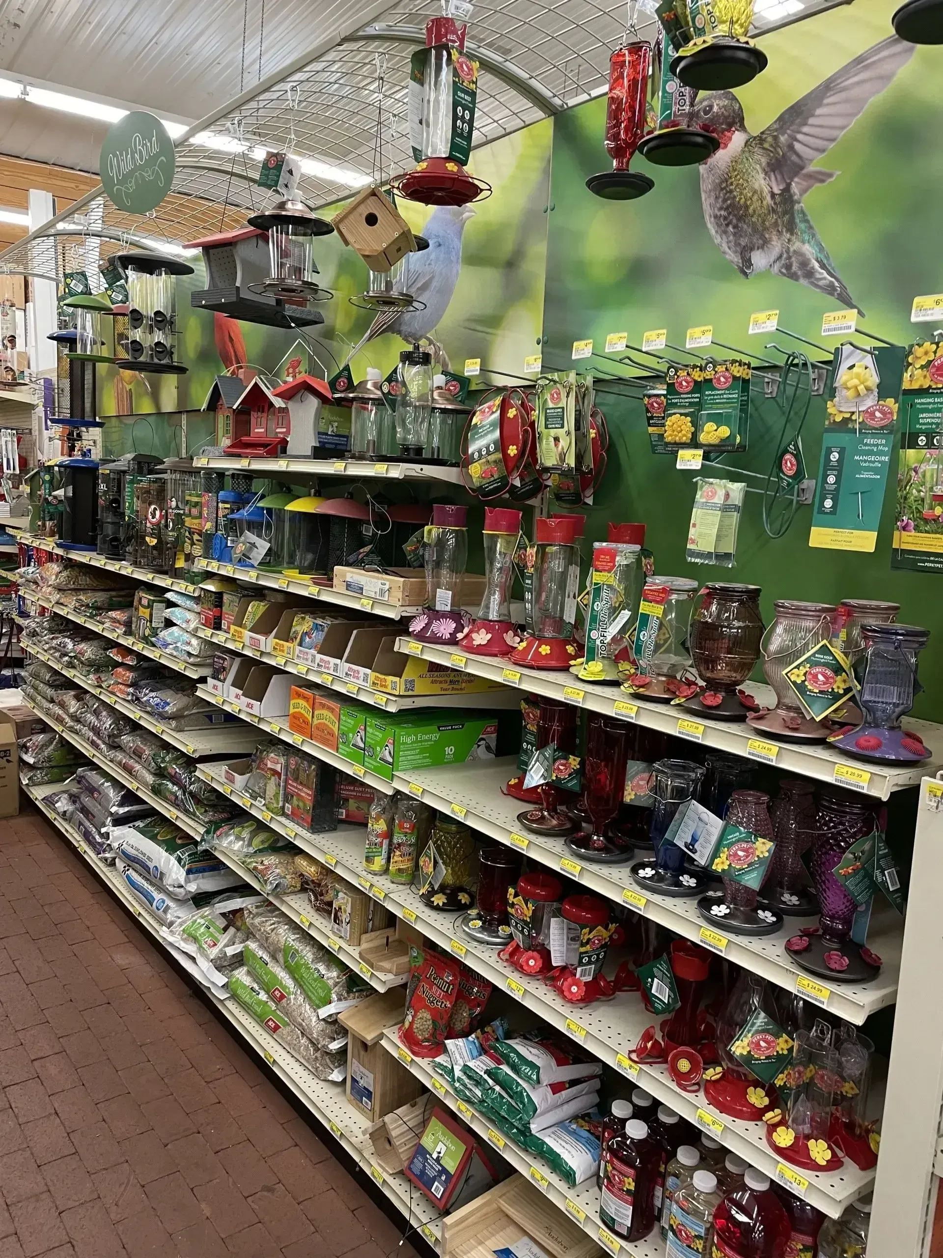 A store aisle filled with lots of bird feeders.