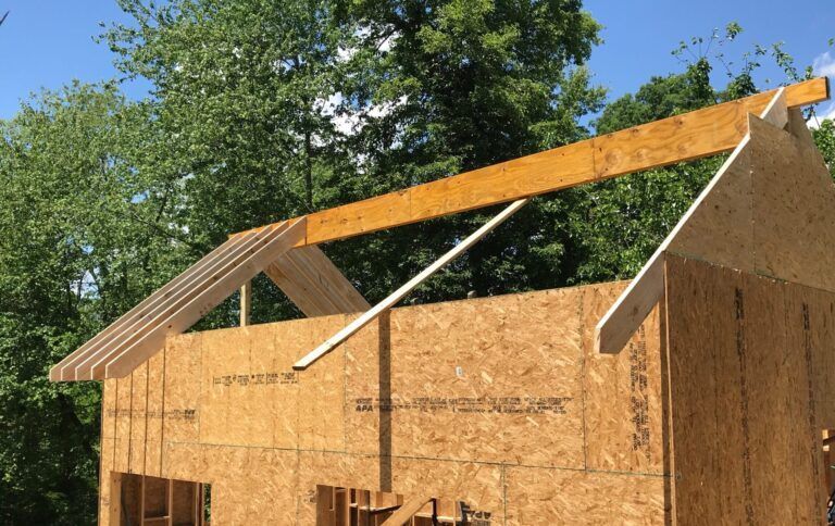 A house is being built with a wooden roof.