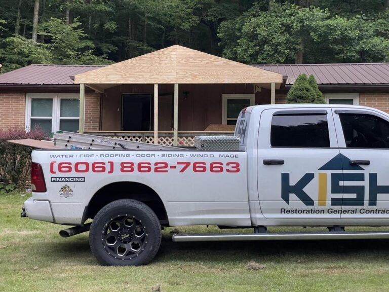 A white truck is parked in front of a brick house