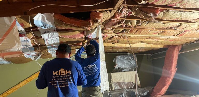 Two men are working on a ceiling in a basement.