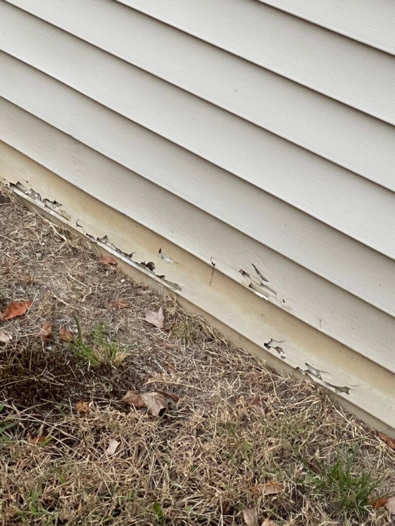A close up of a white siding on a house.