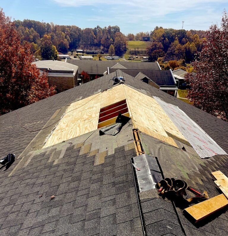 A roof with a hole in it is being repaired