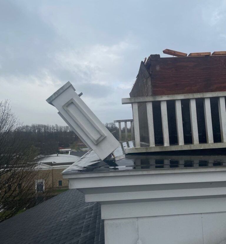 The roof of a house has been damaged by a storm