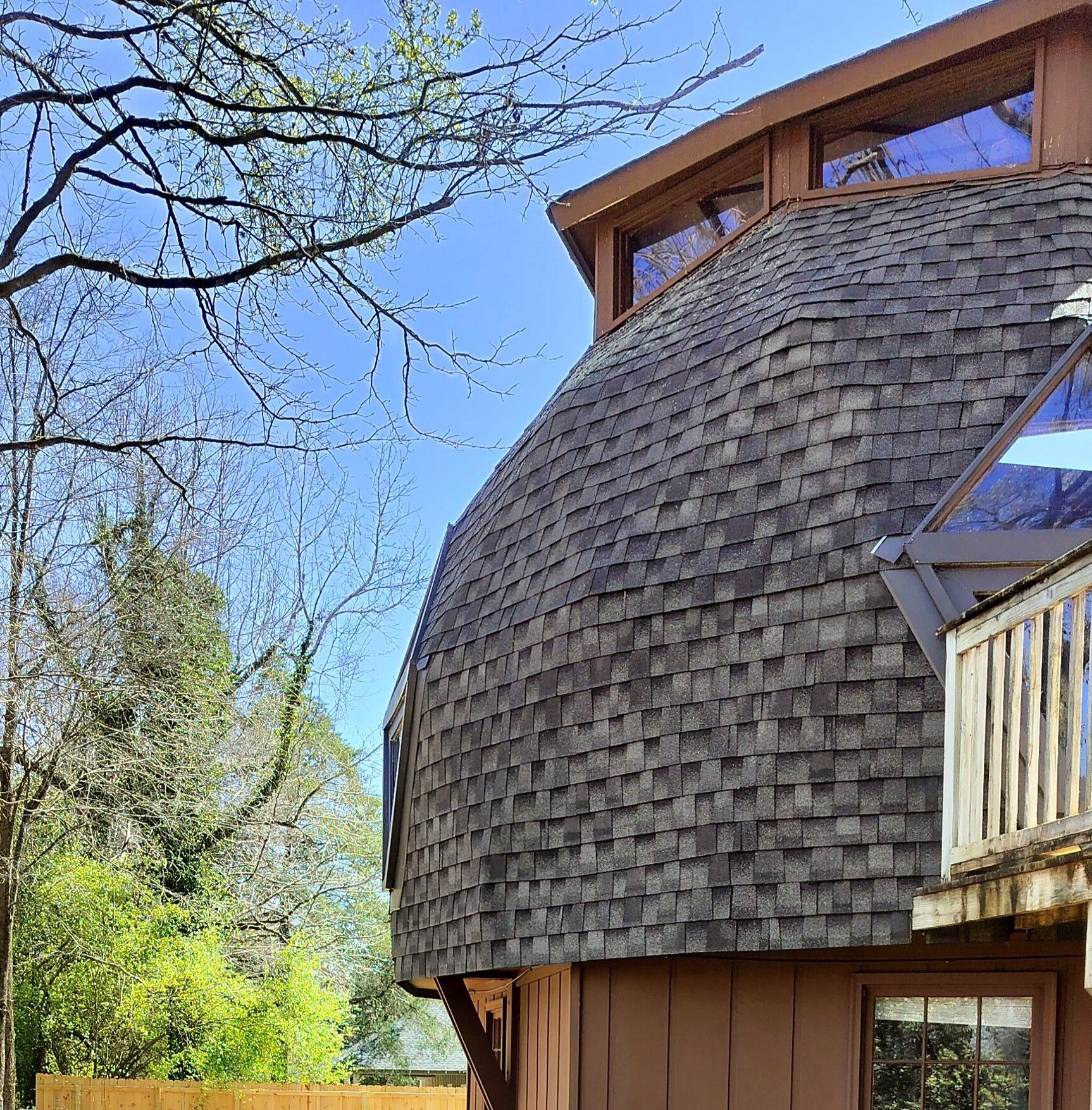 A house with a dome shaped roof and a balcony