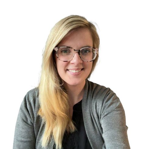 Blonde woman with glasses smiles, wearing gray cardigan over a black top. Hayley Craner, NP in CNY