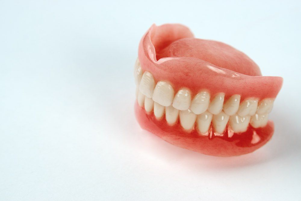 A Close Up of a Denture on a White Surface — Complete Denture Clinic in Kanwal, NSW