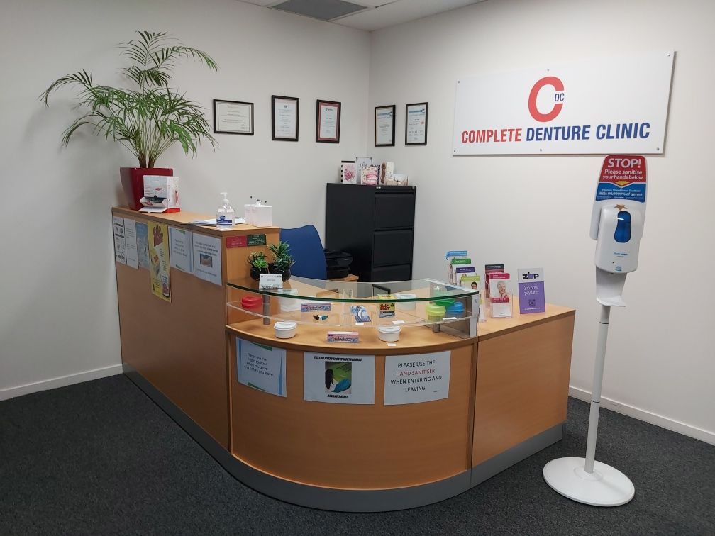 A Dental Office With a Counter and a Sign That Says Complete Denture  Clinic — Complete Denture Clinic in Kanwal, NSW