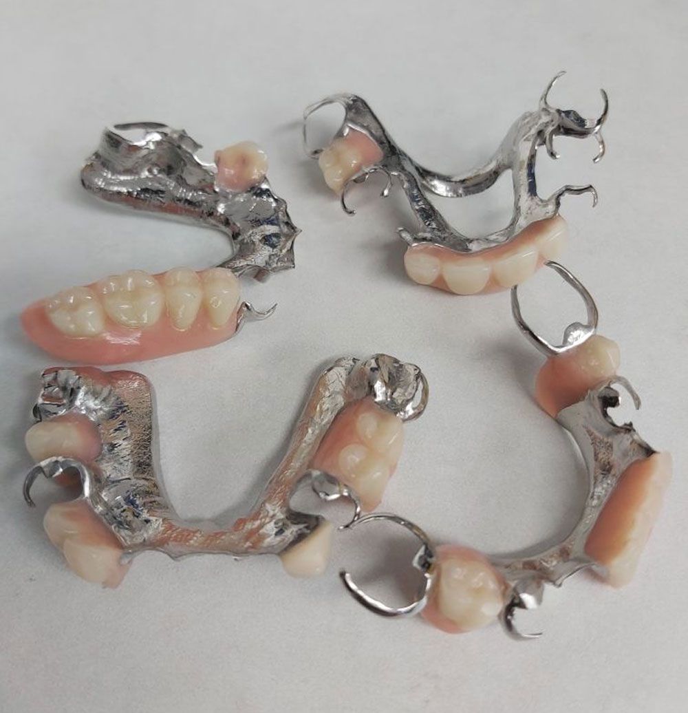 Partial Dentures On The Central Coast On A Table For Repair