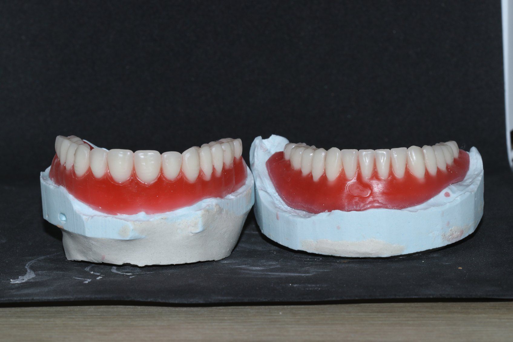 A Pair of Fake Teeth Are Sitting on a Table — Complete Denture Clinic in Kanwal, NSW