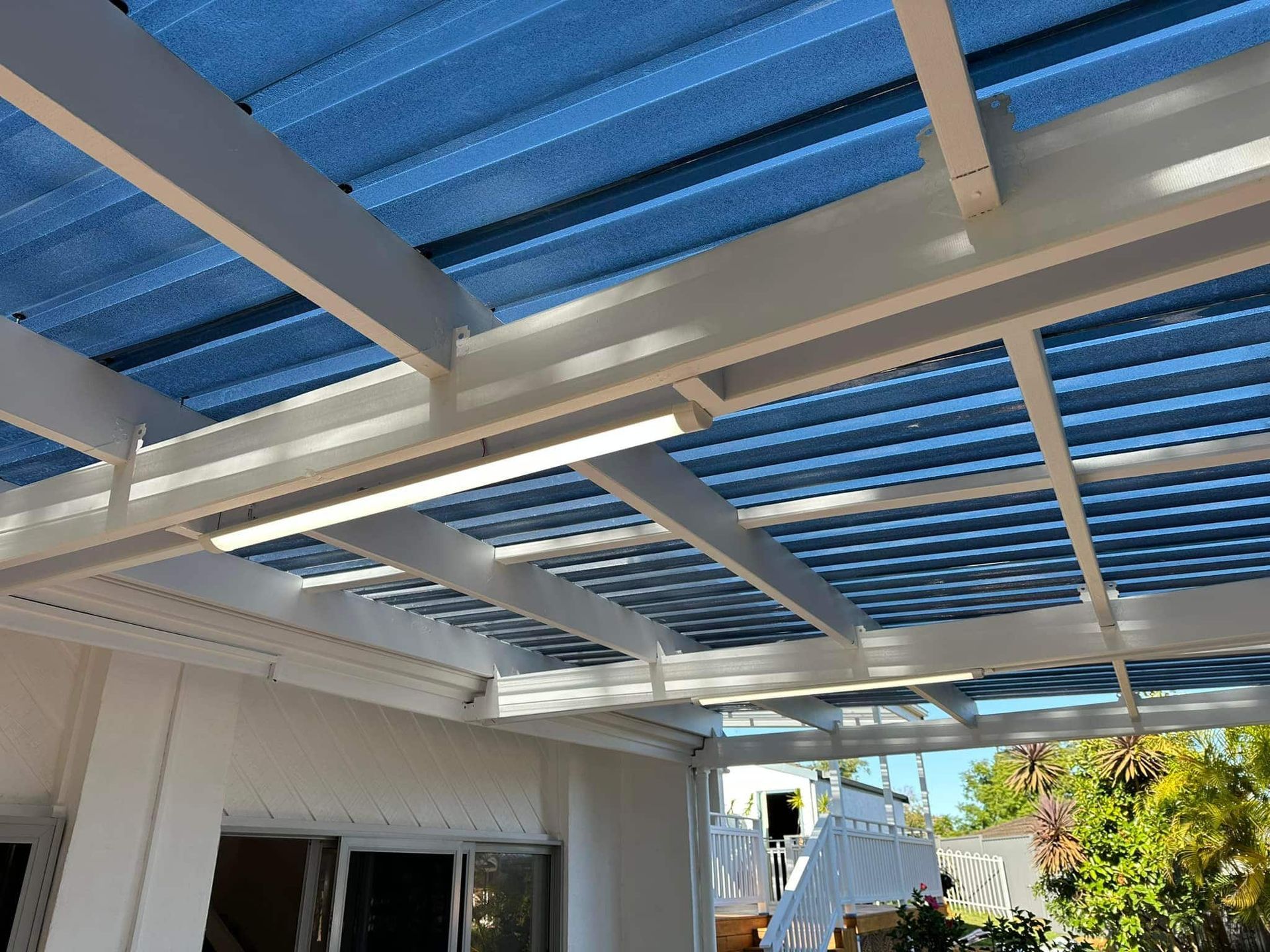 White Pergola Roof With Blue Translucent Panels — SparkSafe Electrical in Gerringong, NSW
