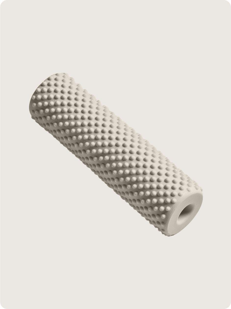White, textured foam roller with raised bumps, angled against a light background.