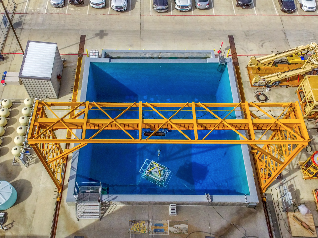 Overhead view of Centurion's large blue industrial water tank with a yellow crane spanning across it.