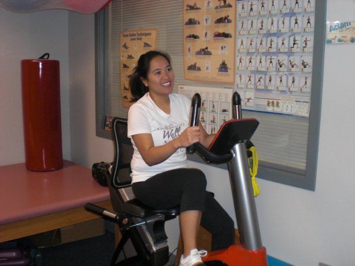Woman riding a stationary bike - physical therapy in Lynnwood, WA