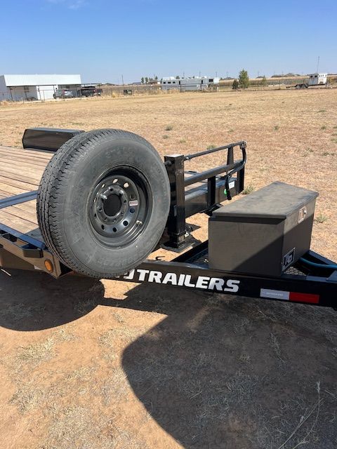 A trailer with a spare tire attached to it