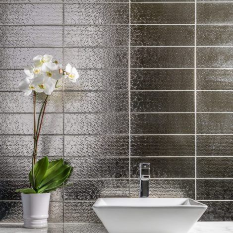 A bathroom with a sink and a potted plant