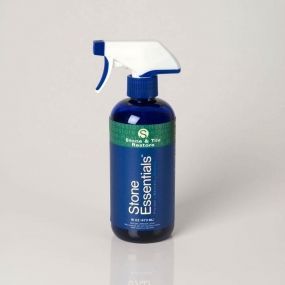 A spray bottle of stone essentials is sitting on a table.