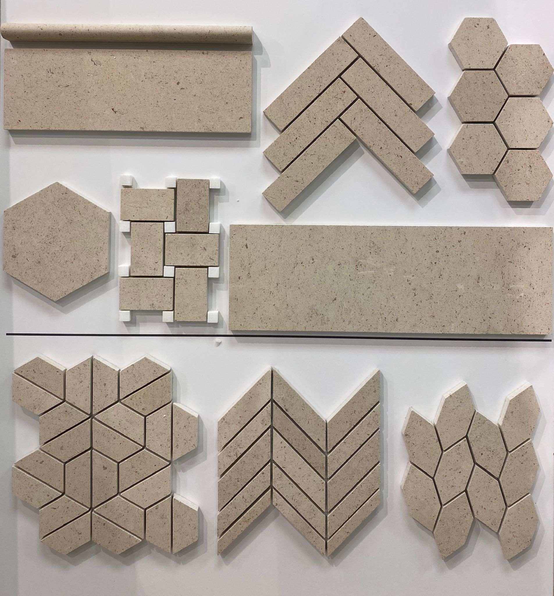 A variety of tiles are displayed on a white surface