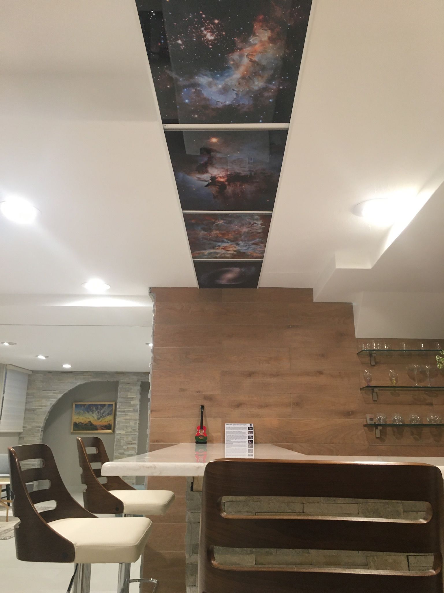 A room with a ceiling that has a picture of a galaxy on it