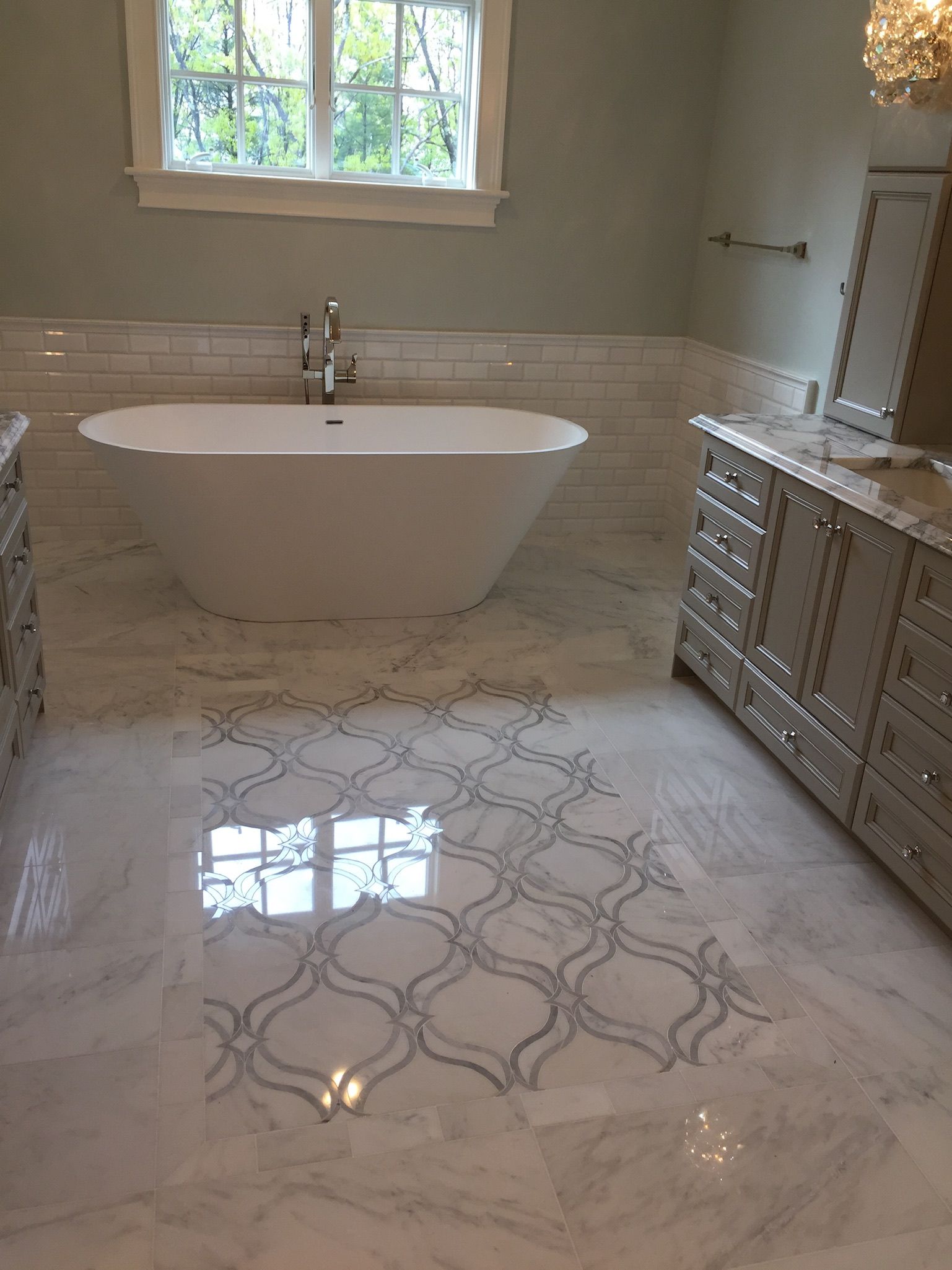 A bathroom with a bathtub and a window