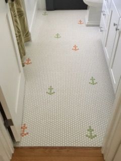 A bathroom floor with anchors painted on it