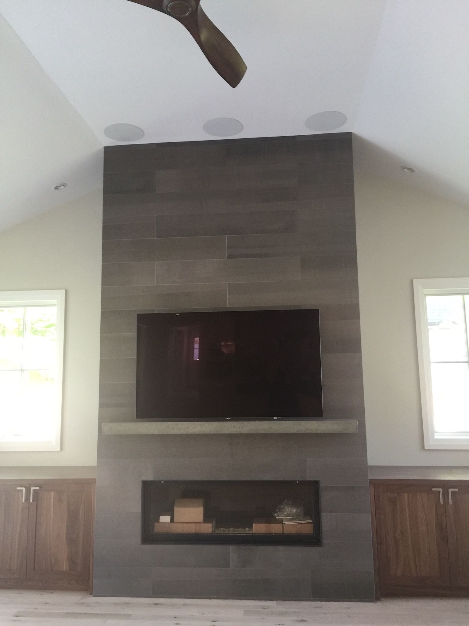 A living room with a fireplace and a flat screen tv.