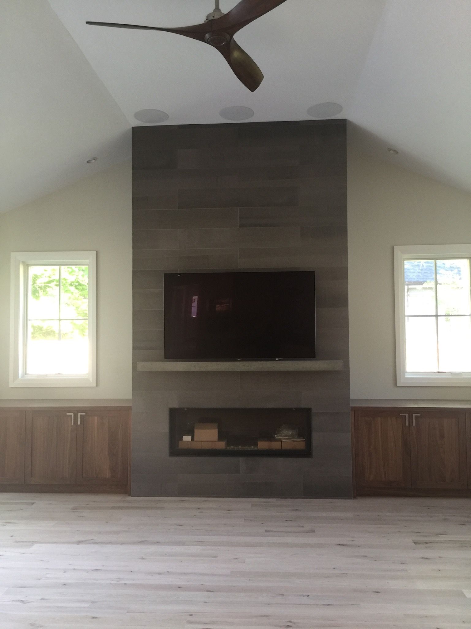 A living room with a fireplace and a flat screen tv