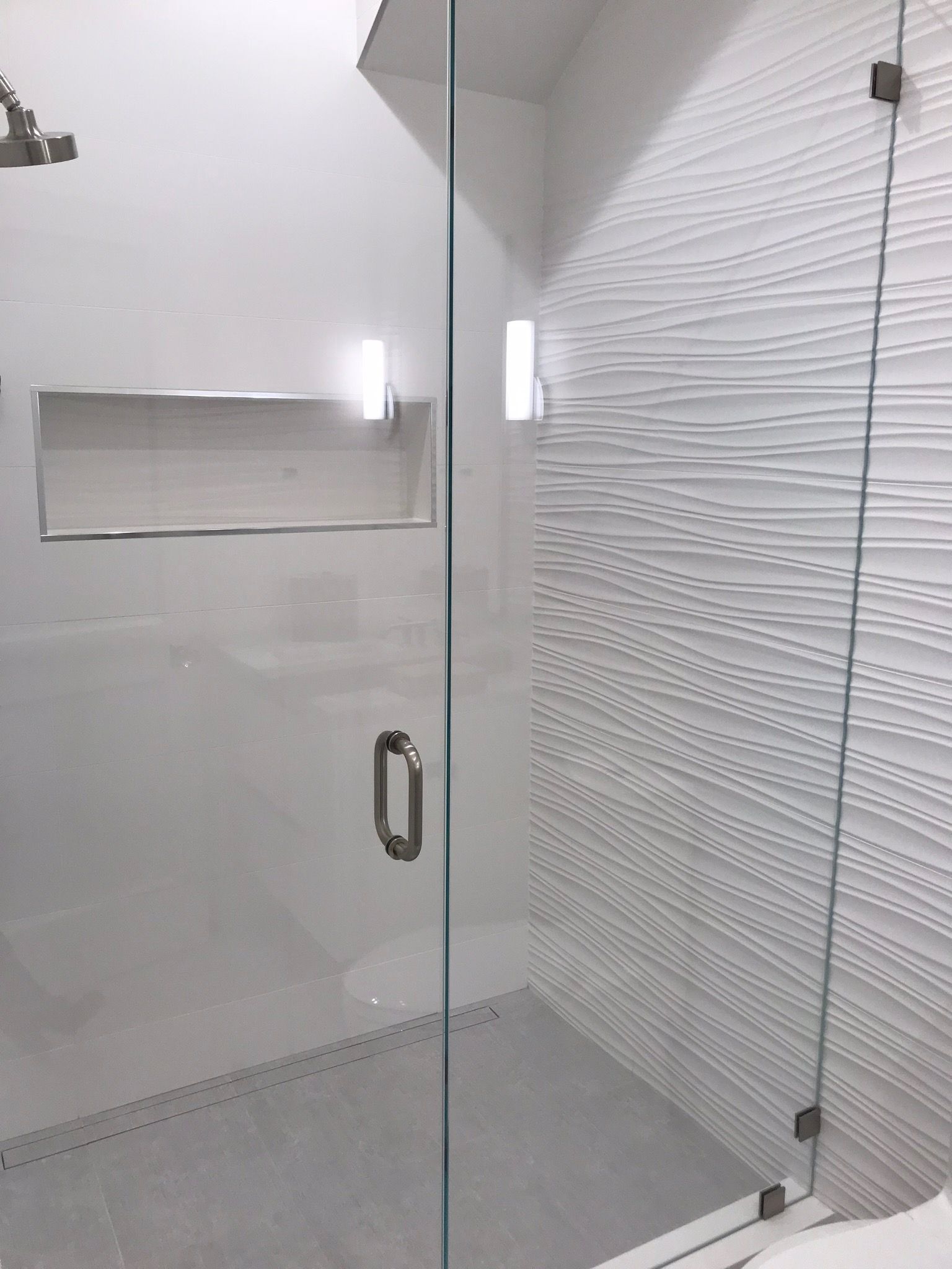 A bathroom with a walk in shower and a toilet.