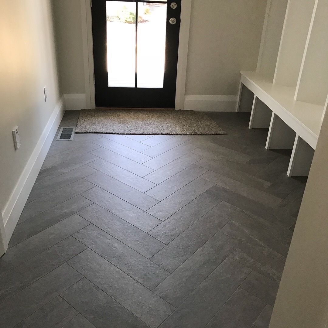 A hallway with a herringbone pattern on the floor