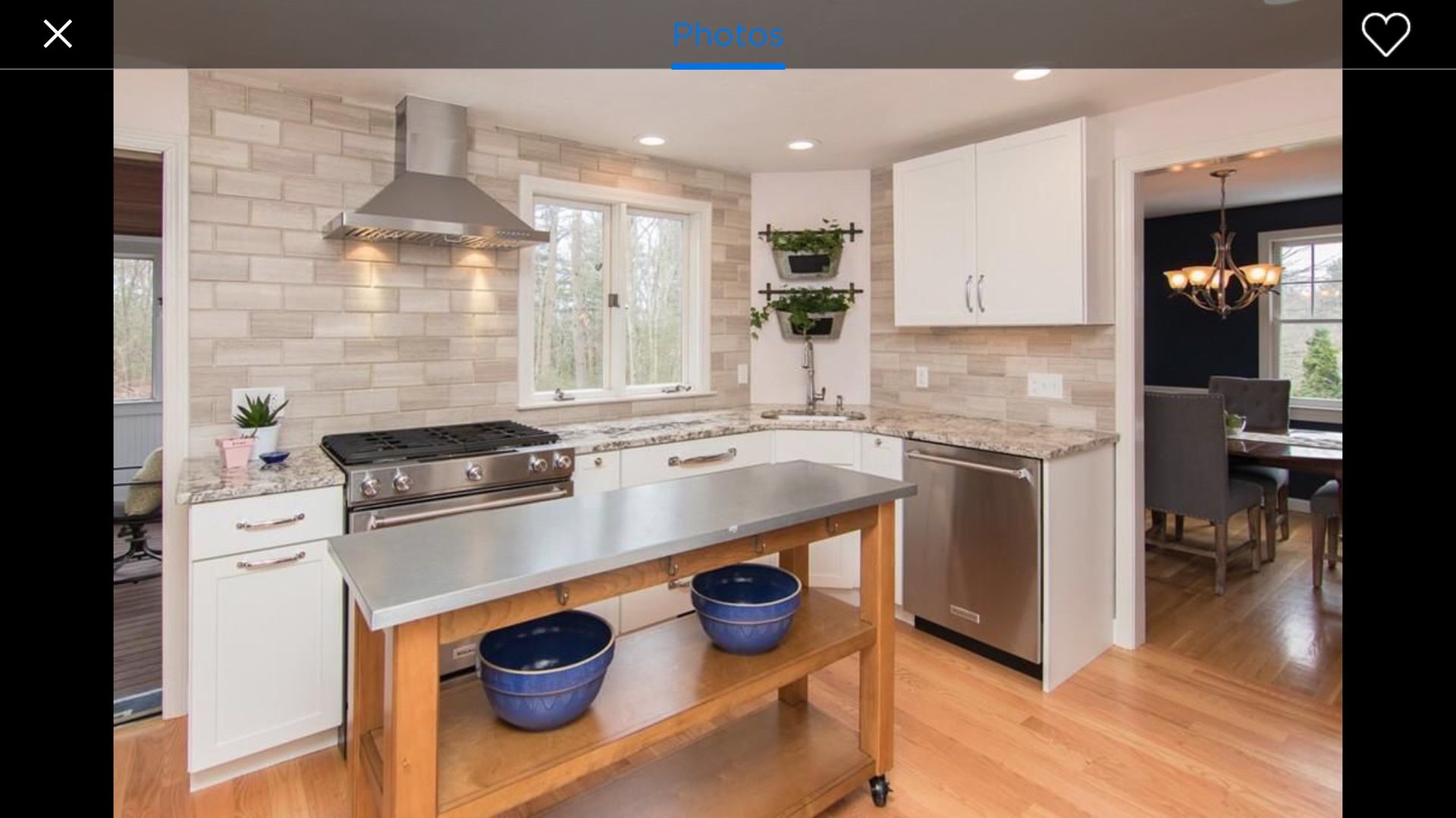 A kitchen with stainless steel appliances and a wooden island