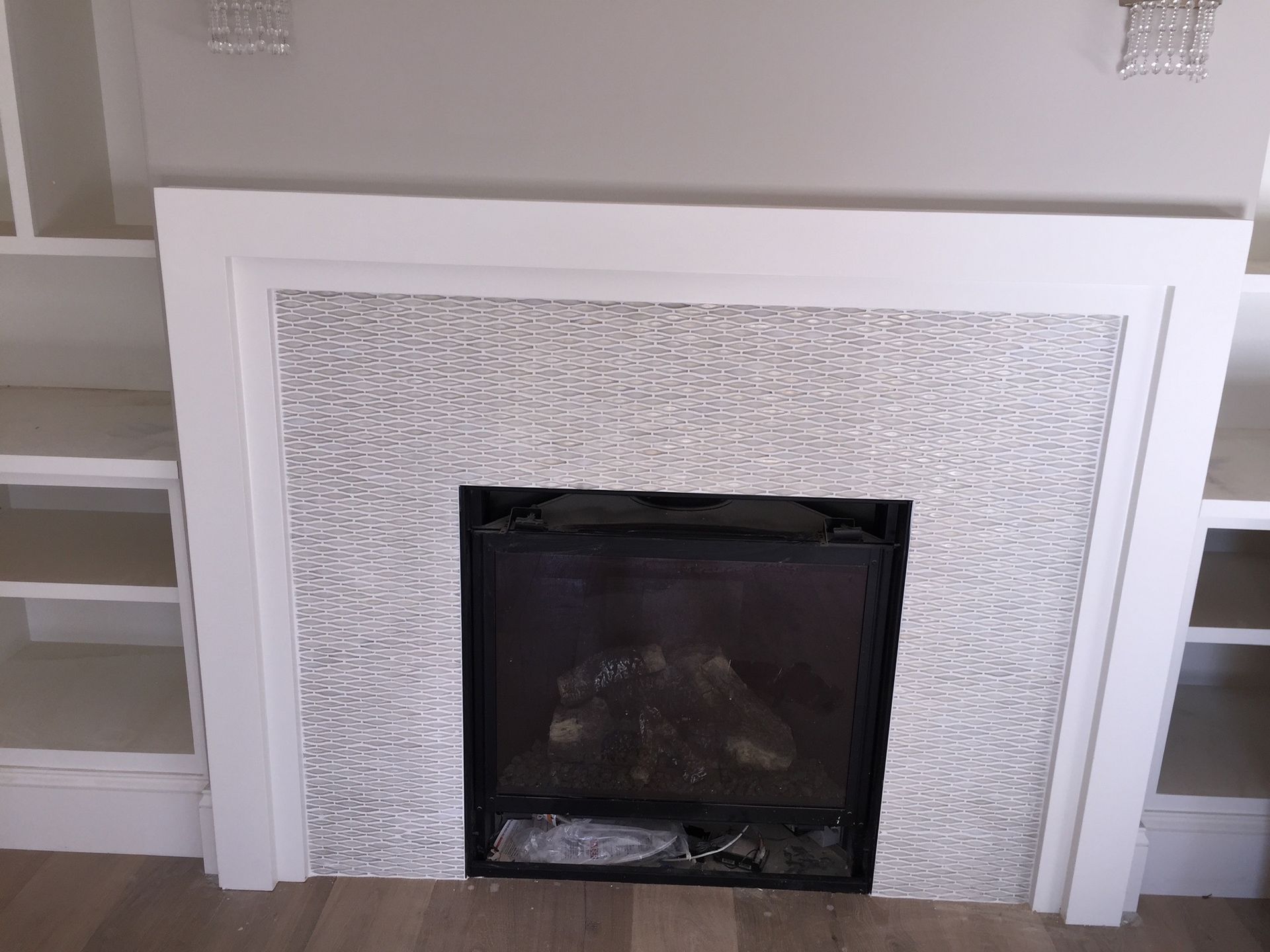 A fireplace in a living room with a white frame