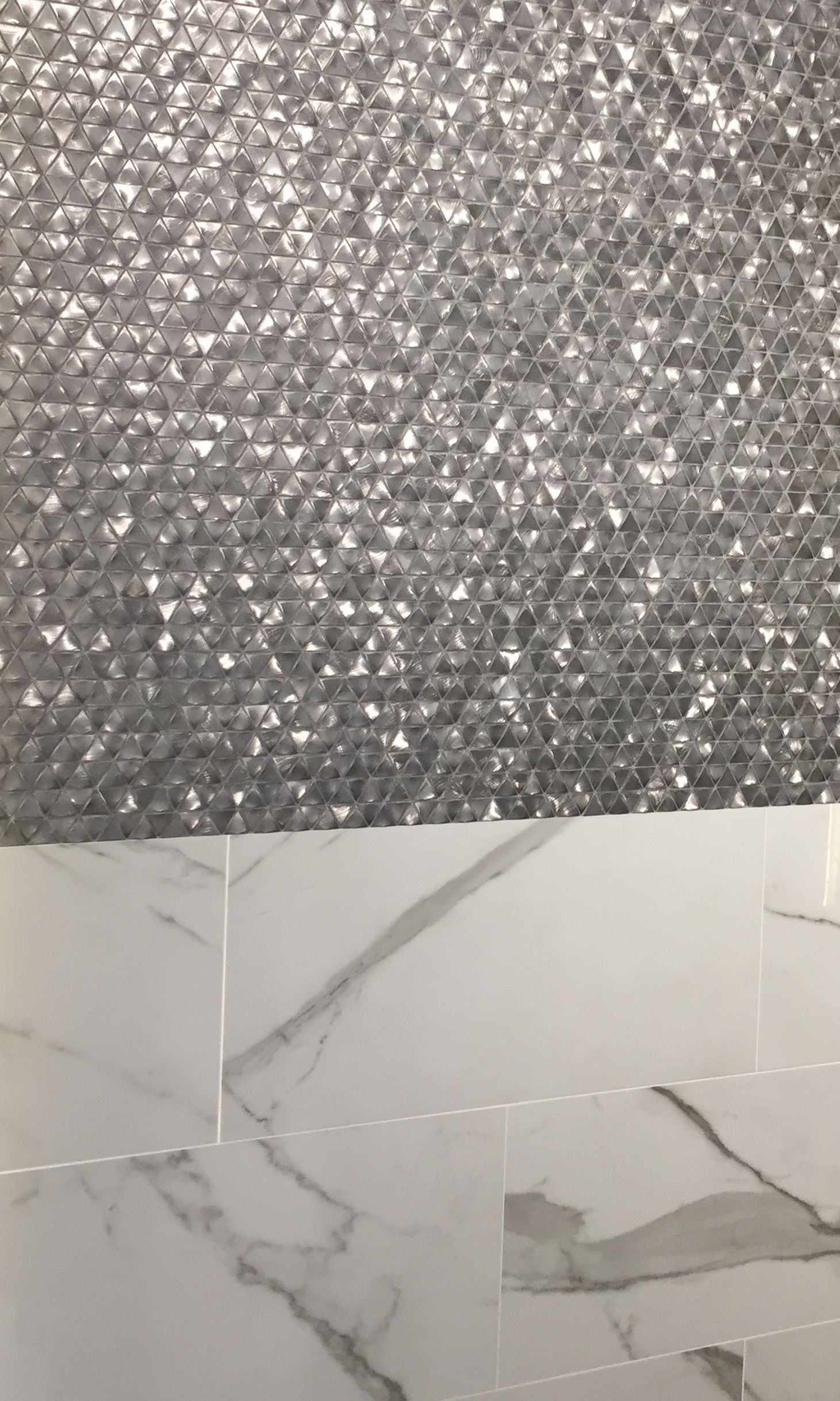 A close up of a tile floor with a marble counter top.