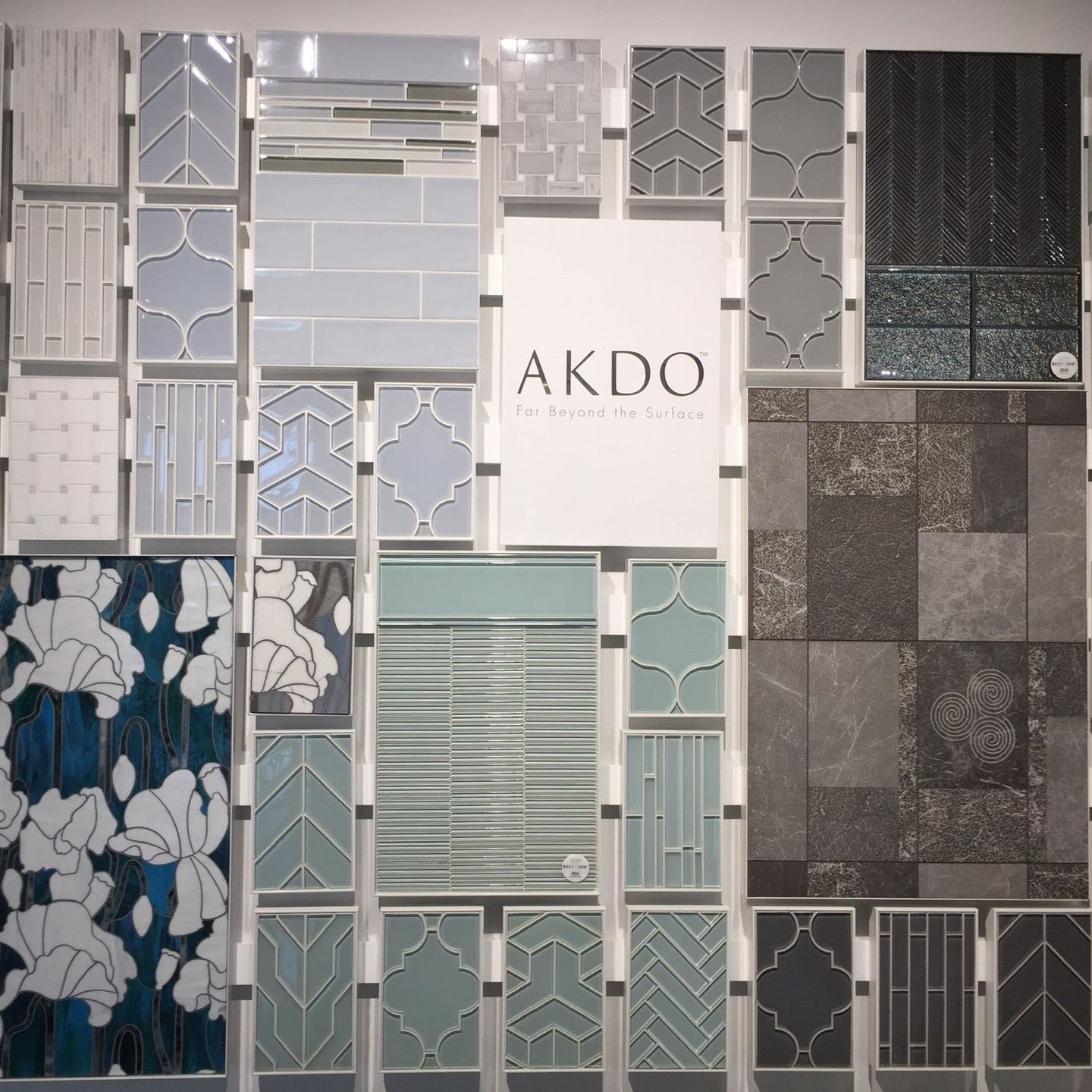 A wall of tiles with a sign that says akdo
