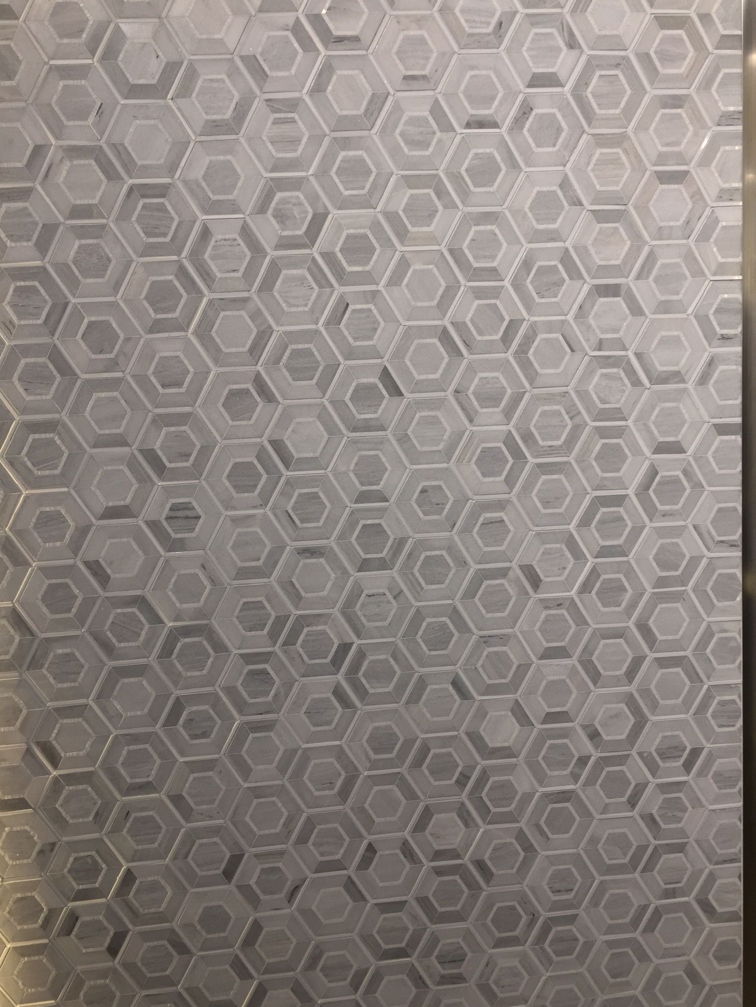A close up of a wall with a honeycomb pattern on it.