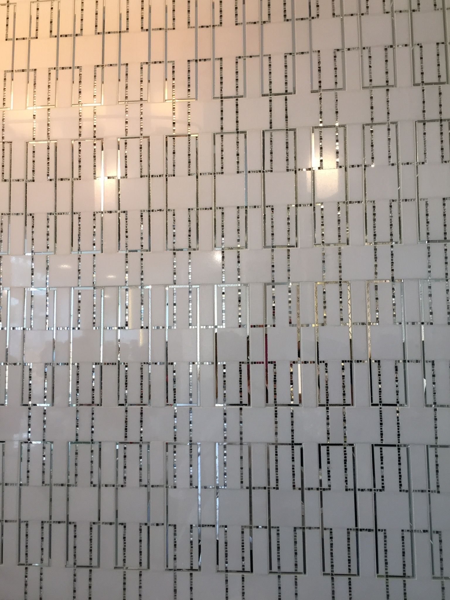 A white wall with a geometric pattern on it