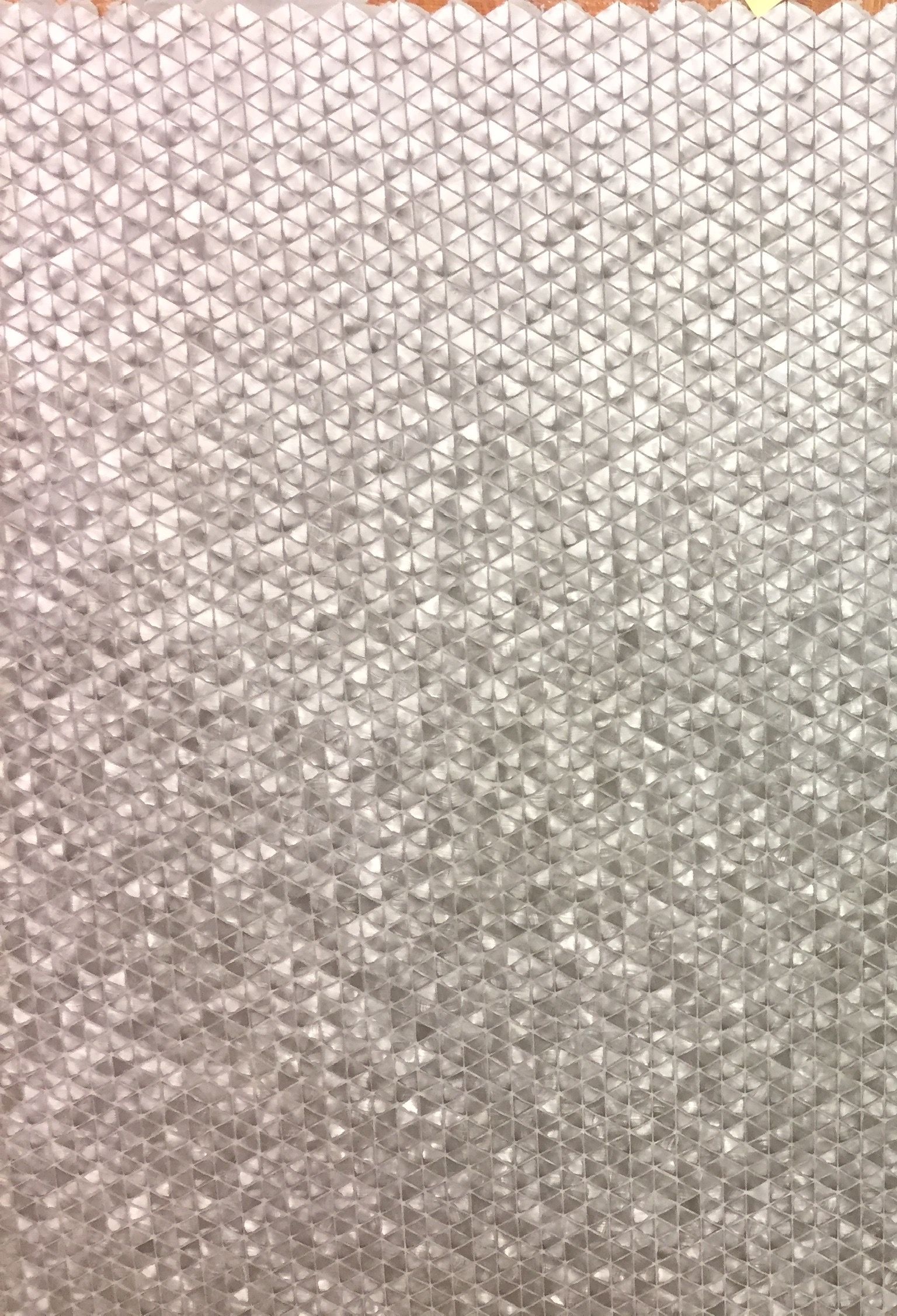 A close up of a piece of white fabric with a geometric pattern.