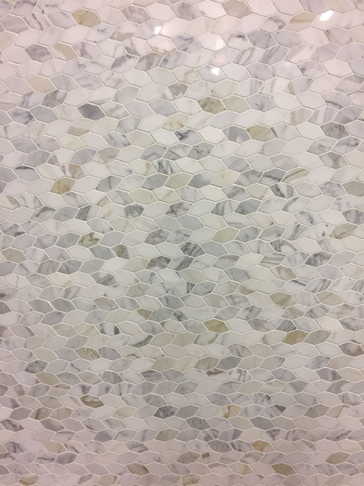 A close up of a white tile with a pattern on it.