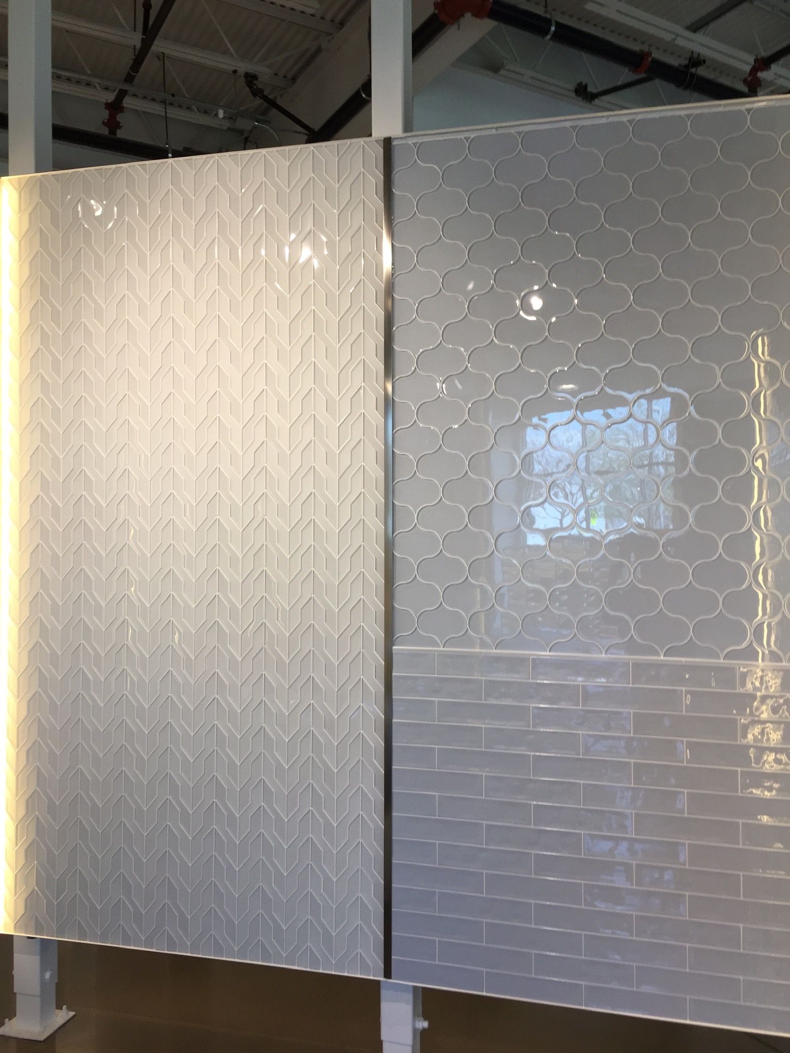 A white brick wall with a light behind it