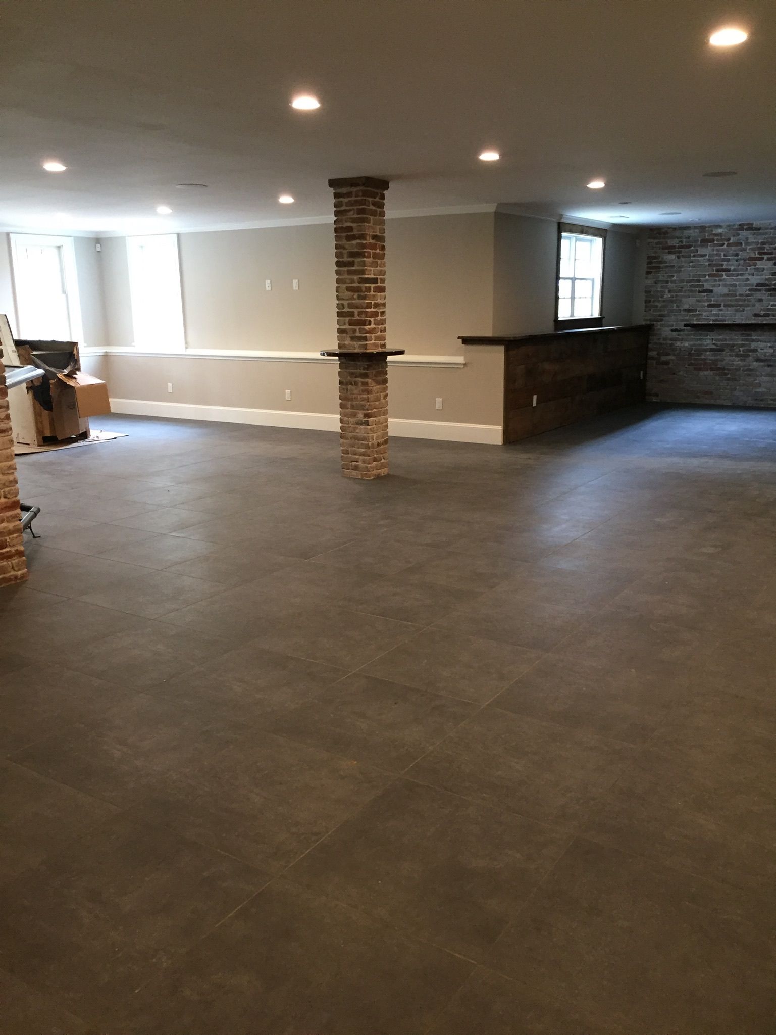 A large empty room with a stone column in the middle.