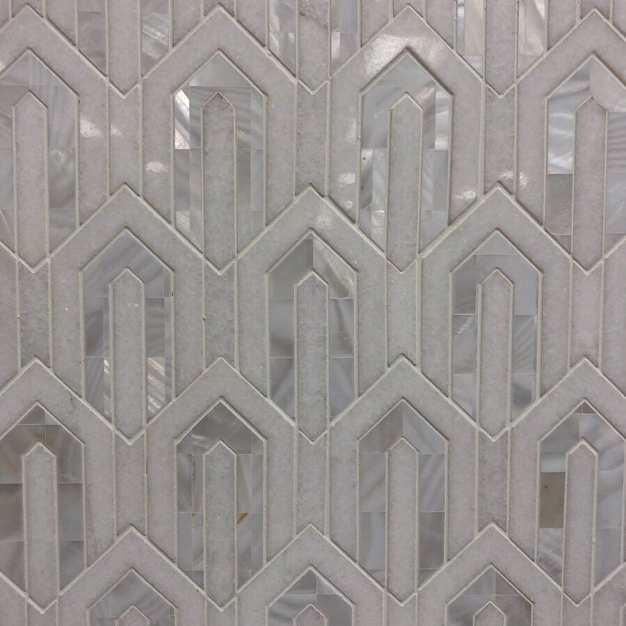 A close up of a tile with a geometric pattern on it
