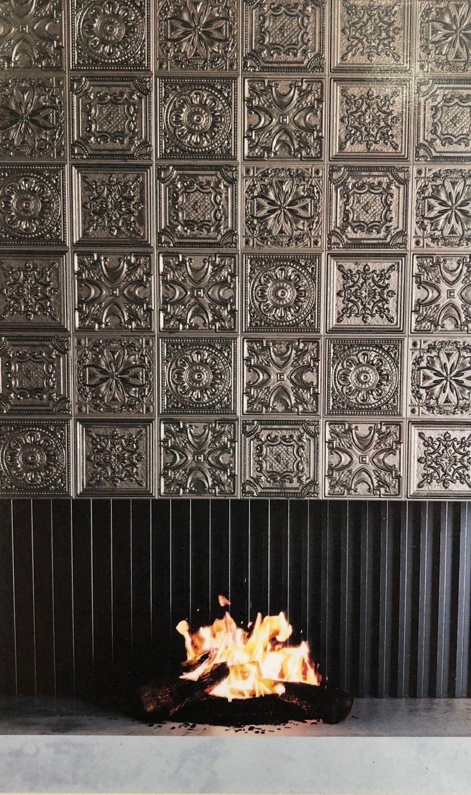 There is a fireplace with a lot of fire in it.