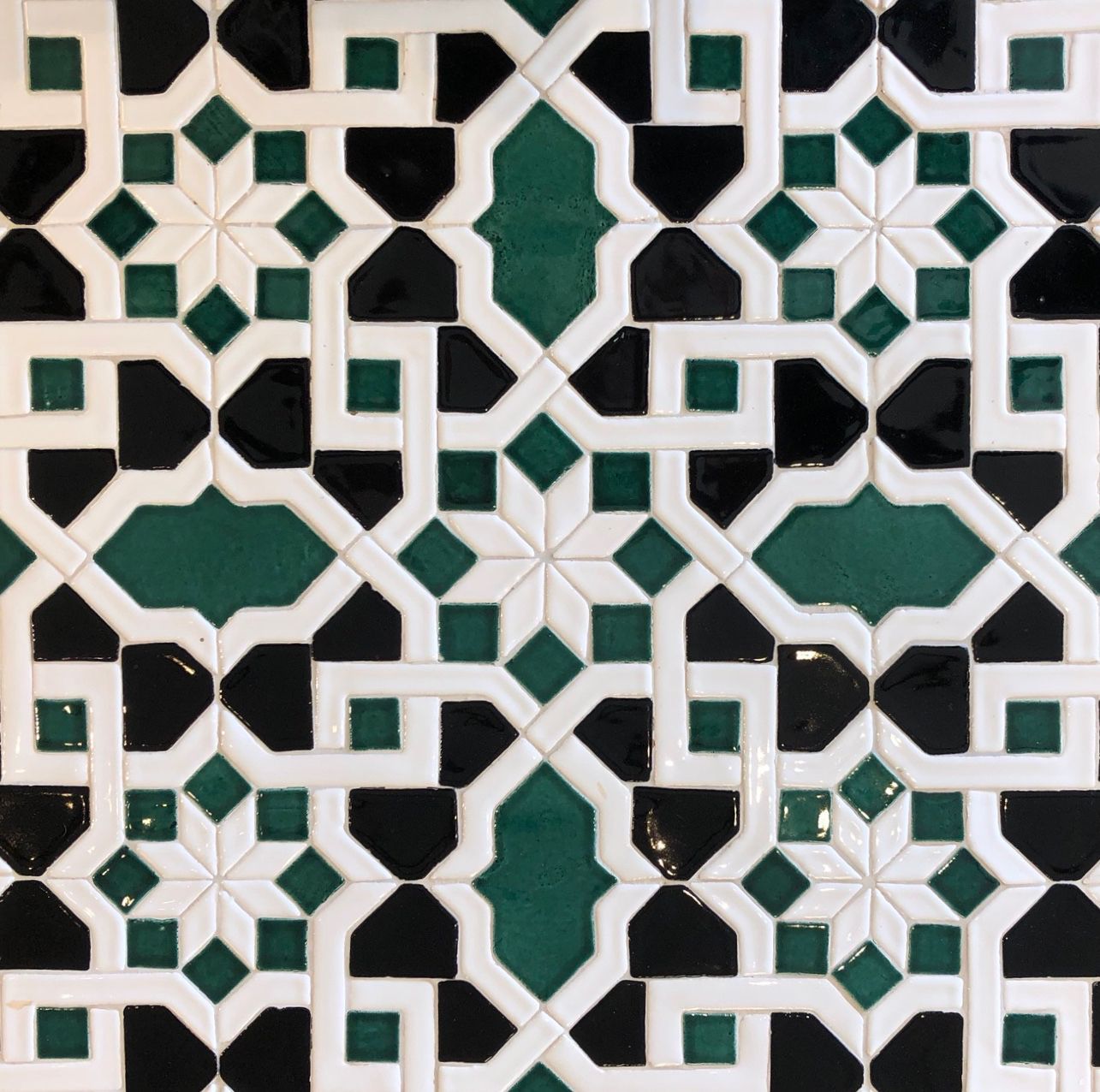A black and white tile with a geometric pattern