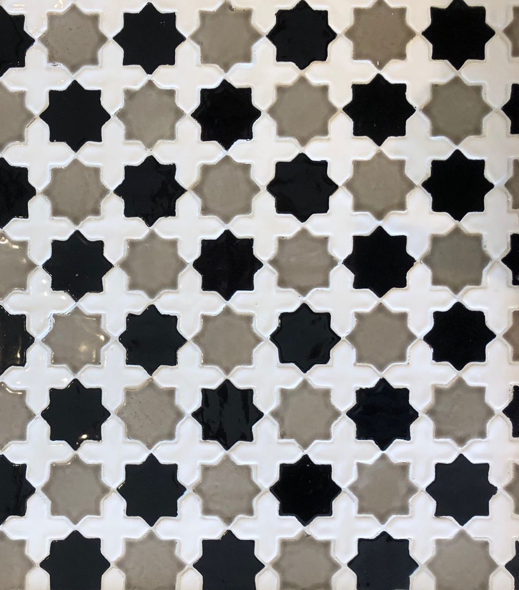 A close up of a black and white tile pattern