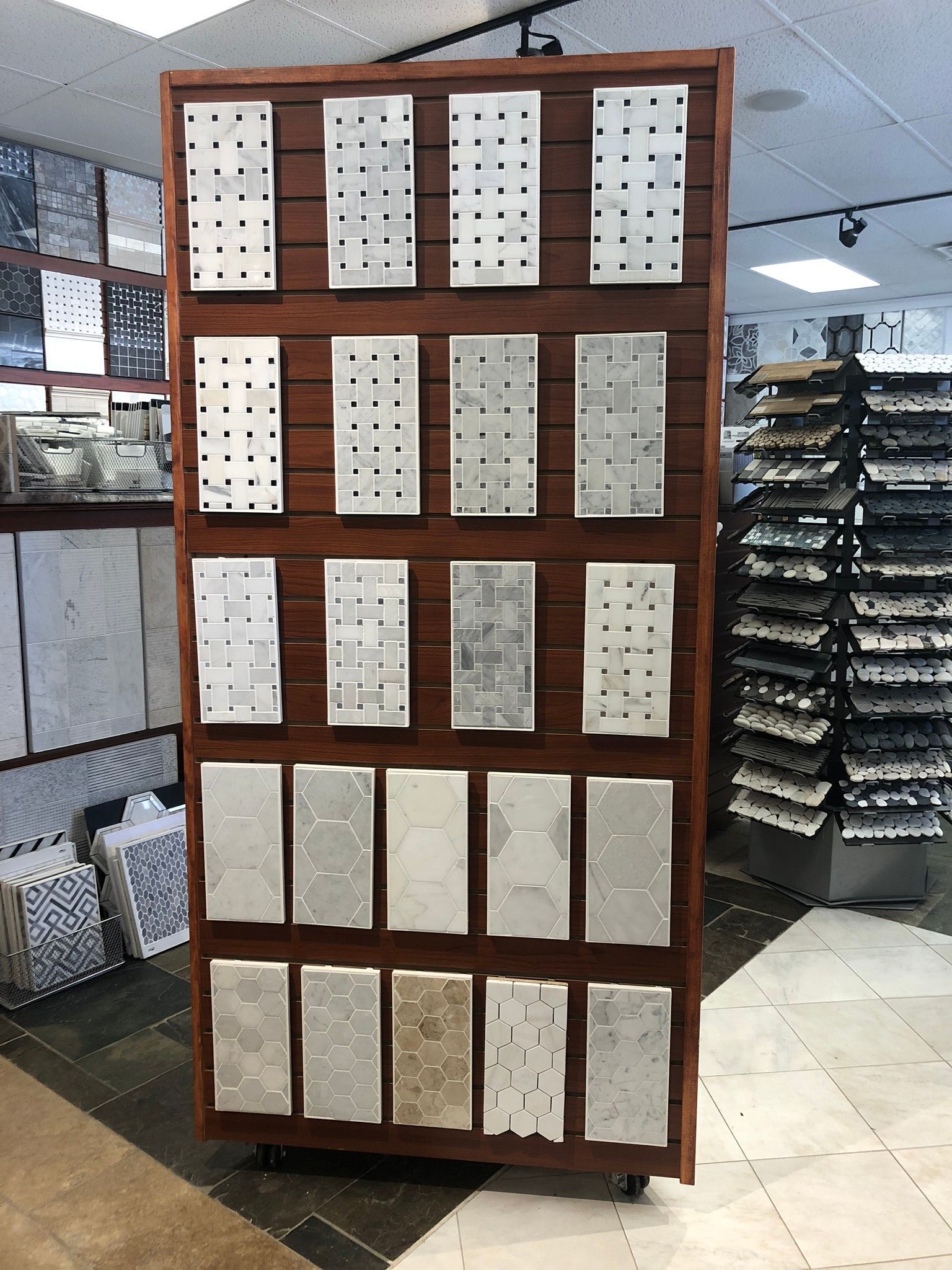 A display of tiles in a store with a wooden frame