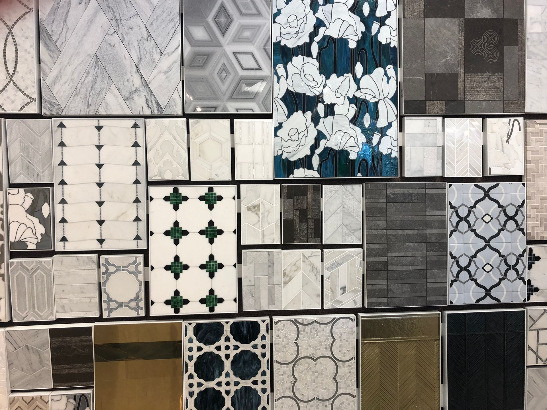 A wall of tiles with different patterns and colors