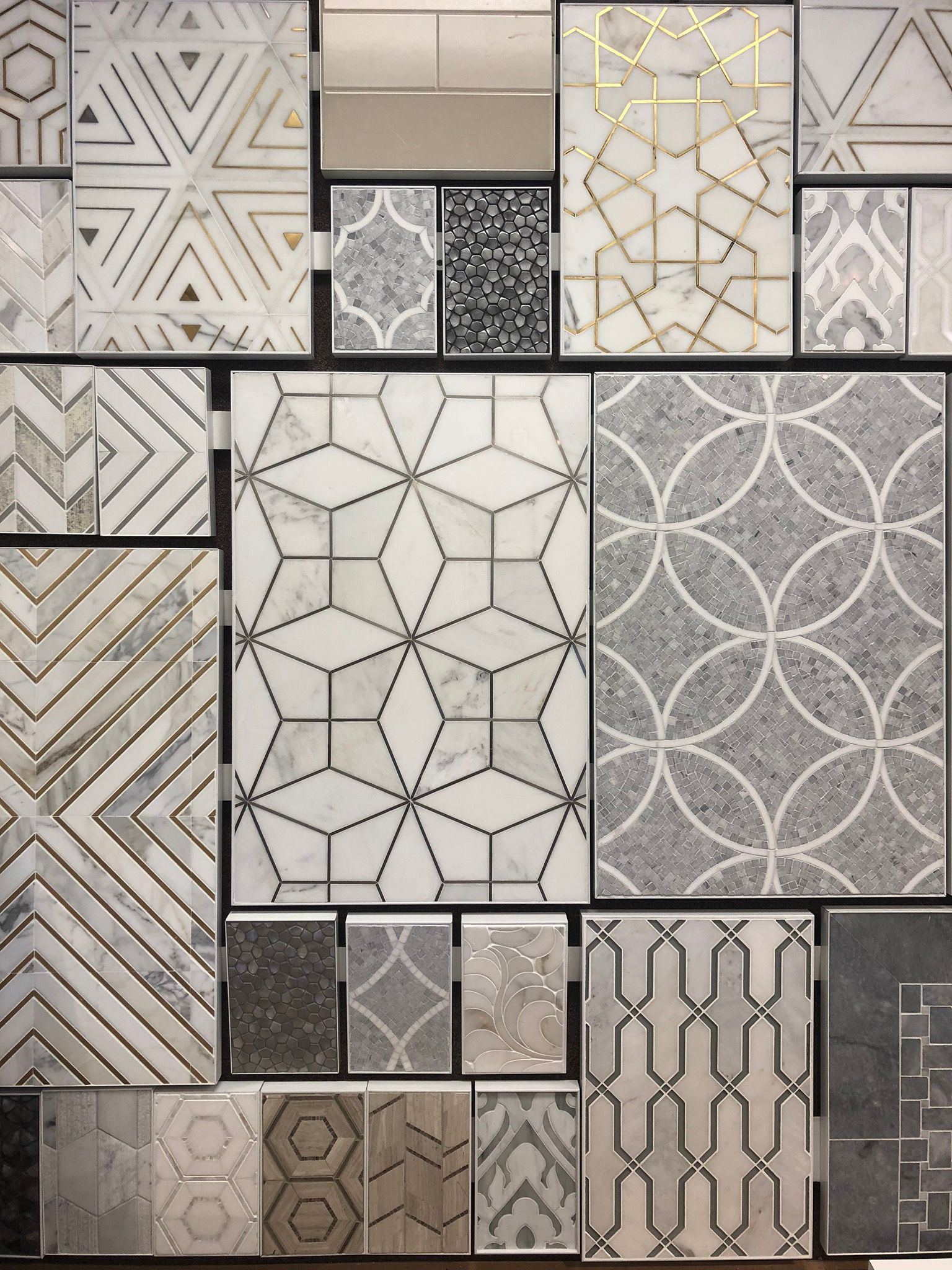 A wall of tiles with different patterns on them