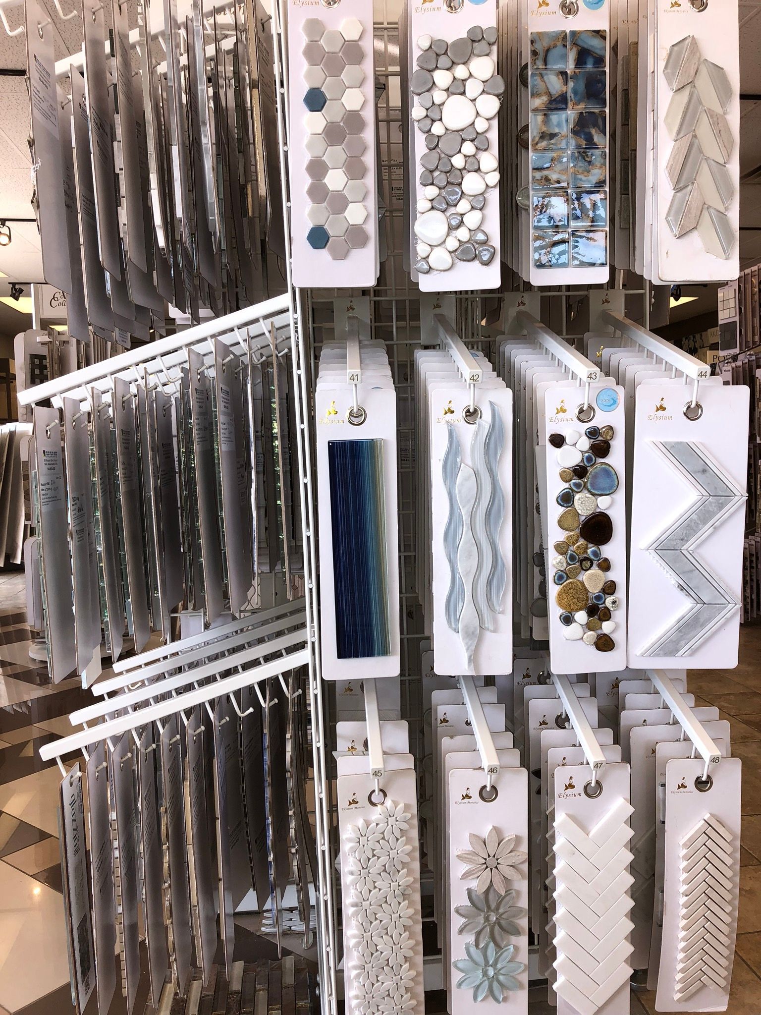 A rack filled with lots of different types of jewelry in a store.