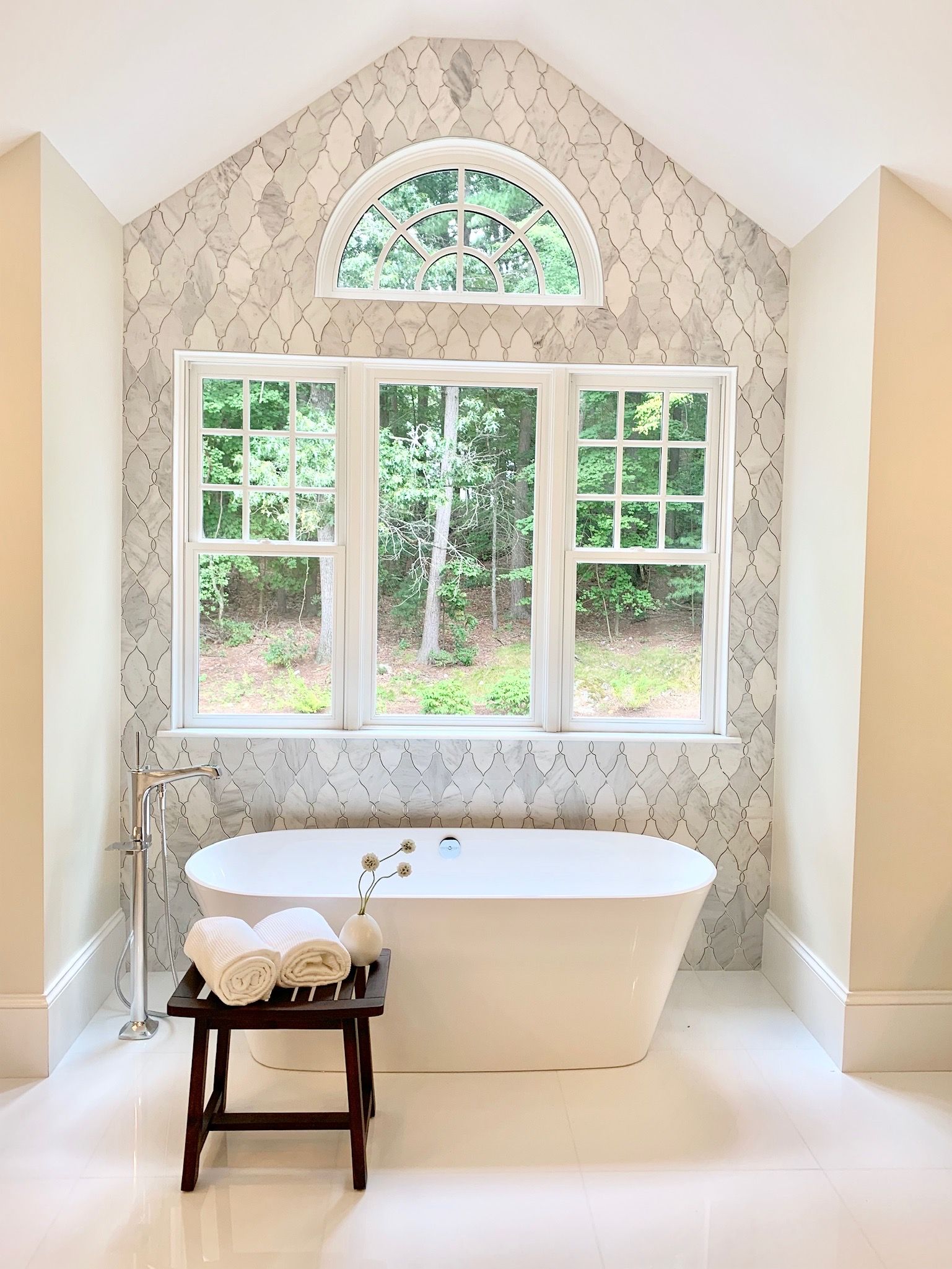 A bathroom with a bathtub and a window.