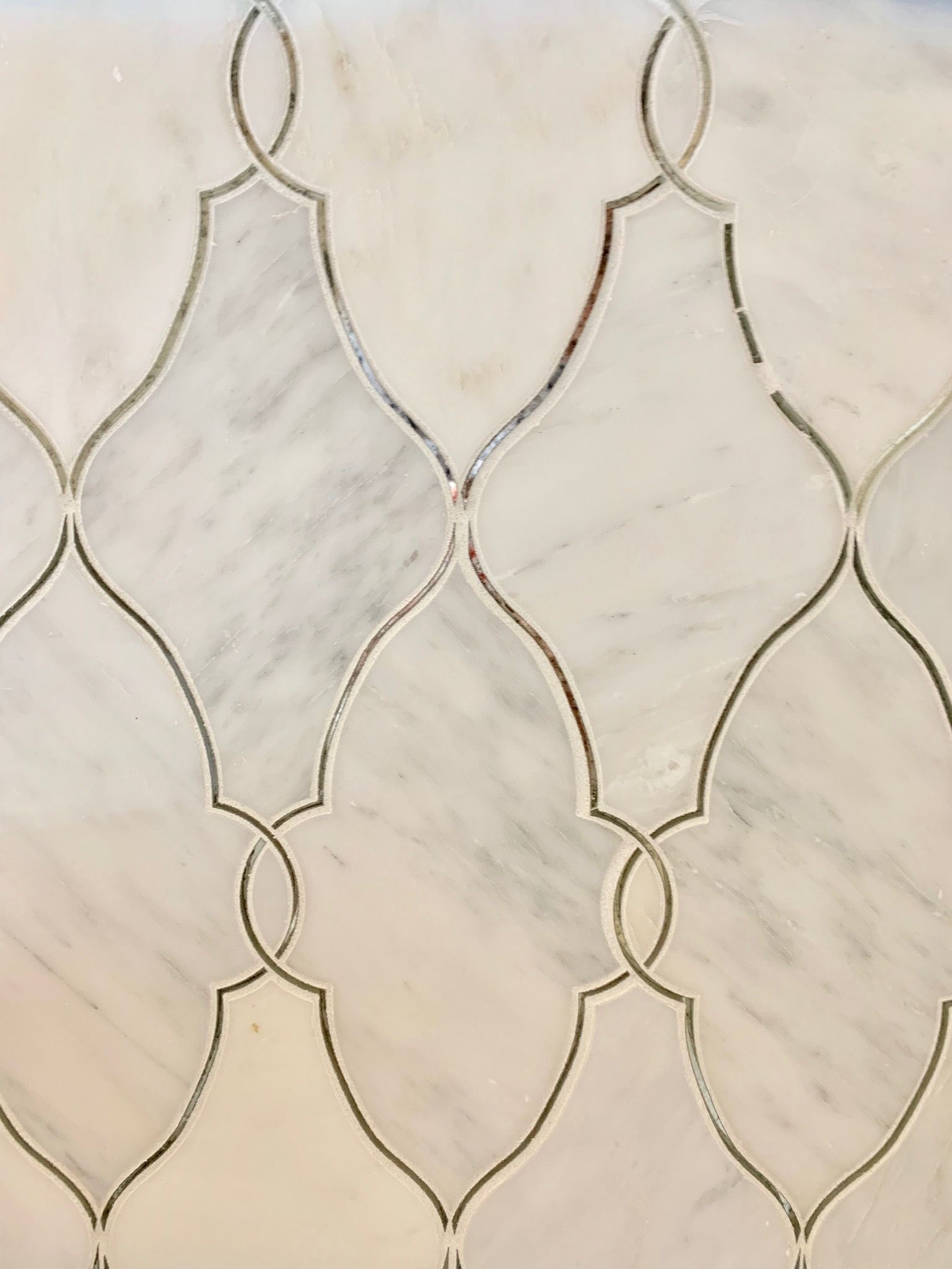 A close up of a white tile with a pattern on it.
