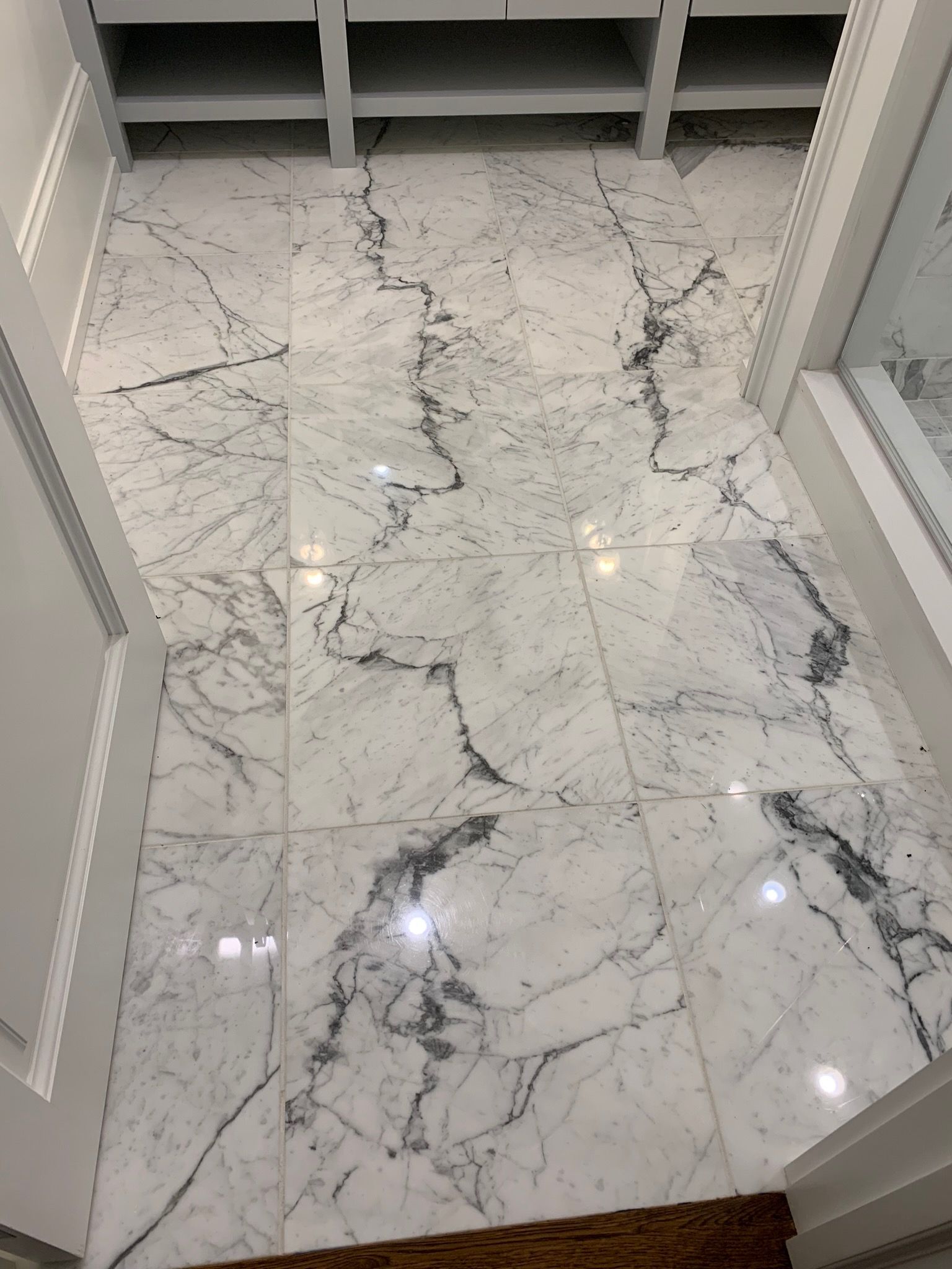 A white marble floor in a walk in closet.