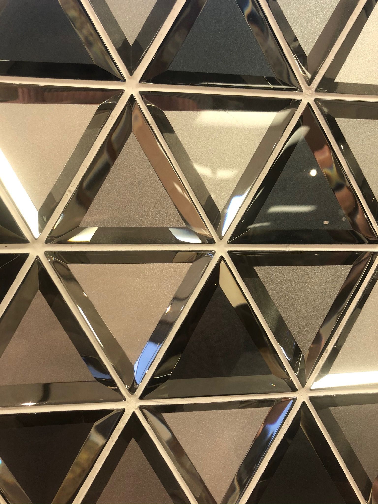 A close up of a wall with triangles on it